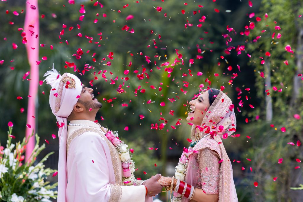 Wedding couple beside flowering trees
